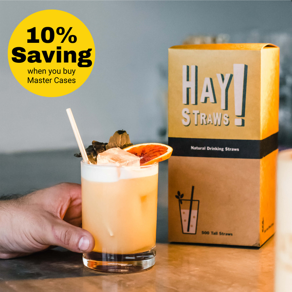 HAY! Straws mastercase of cocktail straws give a bulk purchase discount of 10% savings, image shows a mans hand holding a lowball cocktail glass with a natural HAY straw and on all HAY straws master case purchases, discount built into price box of 500 straws packaged plastic