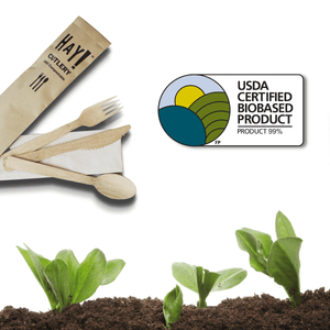 HAY Bamboo Cutlery About Page, Image shows HAY Bamboo Cutlery and USDA Certified Biobased product offical label with 99% biobased content with seedlings growing in compost