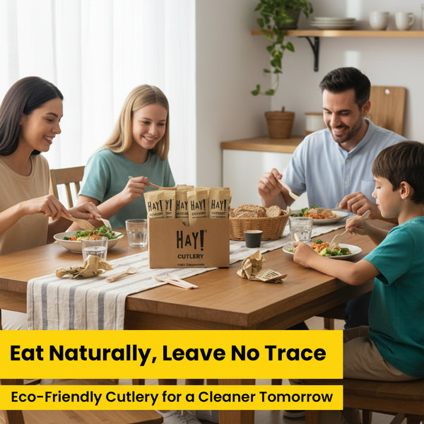 Family at a dining table with HAY! Cutlery boxes, showing eco-friendly cutlery for home parties and dinners.