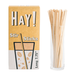 HAY! Stir Sticks displayed in tall glass. Our stirrers are perfect for stirring your favorite hot drink or iced beverage. Available in two sizes, long 7.75" and short 5". They're made from natural wheat stems and tested as gluten-free. Never soggy and 100% compostable. Available in three package quantities: 500 stir stick boxes, 1500 stir sticks and full cases of 3000 Stir sticks.