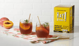 HAY! Straws shown in two short cocktail glasses with a HAY! Straws box