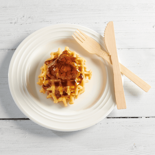 Hay Straws Bamboo Cutlery, unwrapped bamboo cutlery fork,  knife on a dessert plate of waffles