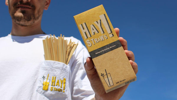 Hay Straws package with wheat straws in a Hay Straws T-shirt