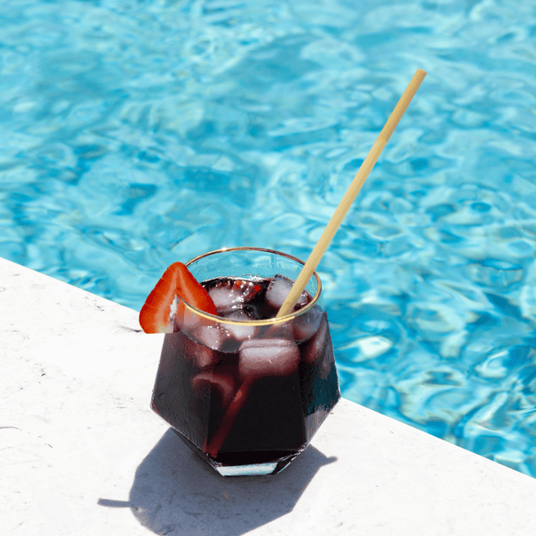 HAY Straws Jumbo Slim Straws made from reed plant stems, a biodegradable drinking straw in a cocktail glass by the pool, 8” length, non soggy straws, compostable straws, natural straws