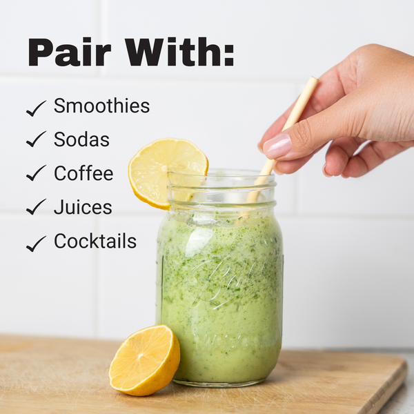The best smoothie straw for green smoothies by HAY straws a hand holding a bamboo looking straw made from reed plant stems in a mason jar with a green smoothie and cut lemon and the words 'Pair With: Smoothies, Sodas, Coffee, Juices, Cocktails' on a light background.