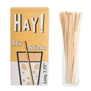 HAY! Stir Sticks displayed in tall glass. Our stirrers are perfect for stirring your favorite hot drink or iced beverage. Available in two sizes, long 7.75" and short 5". They're made from natural wheat stems and tested as gluten-free. Never soggy and 100% compostable. Available in three package quantities: 500 stir stick boxes, 1500 stir sticks and full cases of 3000 Stir sticks. 
