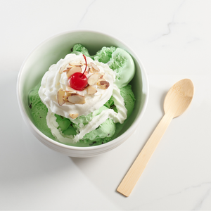 Ice cream sunday with cherry on top and bamboo spoon to replace a single-use plastic spoon