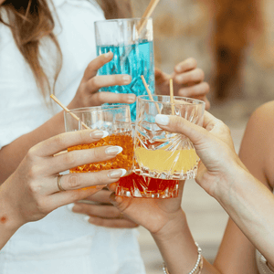 Original HAY Straws, drinking straws made from wheat stems, 100% natural and compostable. Group of people saying cheers with a close up of cocktail drinks with HAY! Straws 